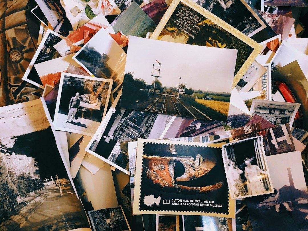A pile of old printed photos and postcards, ready to be sorted